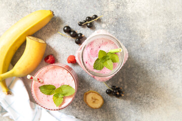 Refreshing mixed berry and banana smoothie with mint garnish.