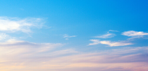 Dramatic sunset sky with yellow sunlight clouds on blue sky background in evening time