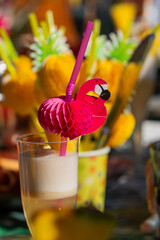 Brightly colored flamingo drink decoration stands out in a refreshing beverage at a festive outdoor gathering in summer