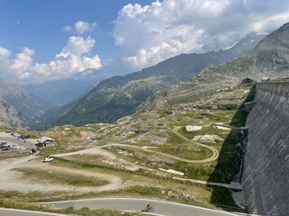 Scenic mountain view from Lago Serr&ugrave;, located in the Gran Paradiso National Park in the Italian Alps. The image captures a winding alpine road
