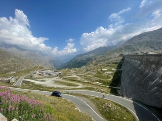 Scenic mountain view from Lago Serr&ugrave;, located in the Gran Paradiso National Park in the Italian Alps. The image captures a winding alpine road