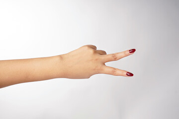 Two fingers showing a V-shaped gesture to the side on a white background