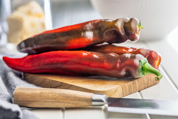 Corno di Toro Rosso pepper. Red paprika vegetable on cutting board.