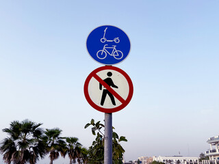 Road sign on the embankment indicating a lane for bicycles and electric scooters. Urban mobility concept.
