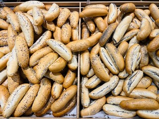 Food commerce and everyday shopping. Sale of bread with a close-up view of bakery products on shelves in a store or bakery.
