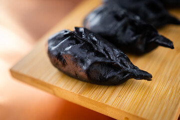 Raw and cooked Japanese gyoza dumplings on rustic surfaces – handmade Asian cuisine