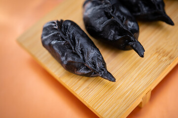 Raw and cooked Japanese gyoza dumplings on rustic surfaces – handmade Asian cuisine