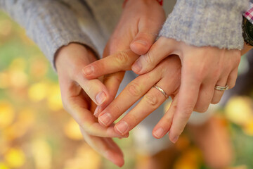 Romantic connection and emotional bonding. A couple holding hands symbolizing love, attachment and healthy relationships. St. Valentine background. No faces.