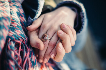 Romantic connection and emotional bonding. A couple holding hands symbolizing love, attachment and healthy relationships. St. Valentine background. No faces.