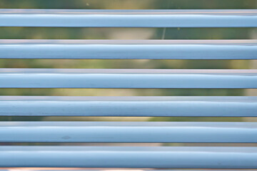 Obraz premium The windows of the house are decorated with white blinds. Close-up, selective focus