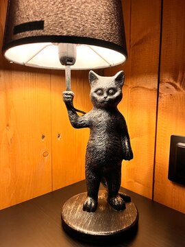 Black decorative table lamp in shape of cat. Bulgakov's Hippopotamus cat