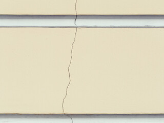 Decorative elements on the wall. Weathered rough cracked painted surface. Empty rectangular place for text, images and ads. Vintage texture for background and design. Closeup.