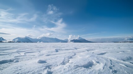 Snow Covered Volcanic Mountains and Frozen Landscape Under Clear Blue Sky