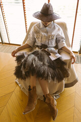 A mysterious woman in an eclectic, avant-garde look combines western and glam styles.