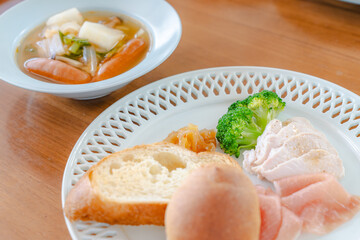 Healthy breakfast with bread, ham, chicken breast and broccoli
