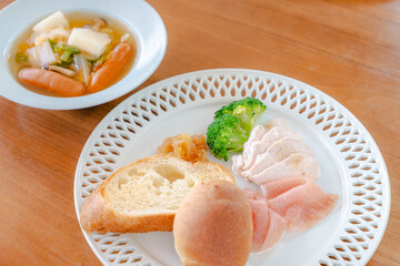 Healthy breakfast with bread, ham, chicken breast and broccoli
