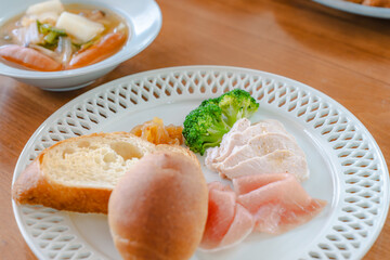 Healthy breakfast with bread, ham, chicken breast and broccoli
