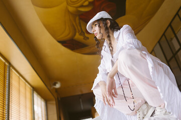A confident woman in a stylish, relaxed outfit at home.