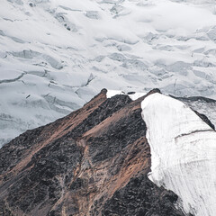A close-up of a mountain peak in bad weather, leading to the death of climbers in windy weather, snow-capped peaks in the clouds