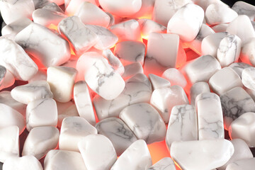 White polished stones texture background and red light