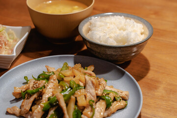 Japanese dinner with pork stir fry, rice, miso soup and salad
