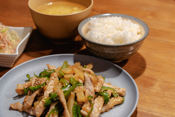 Japanese dinner with pork stir fry, rice, miso soup and salad

