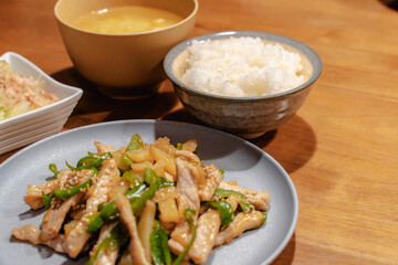 Japanese dinner with pork stir fry, rice, miso soup and salad

