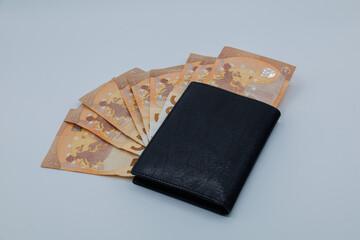 Black wallet with fanned 50 euro banknotes