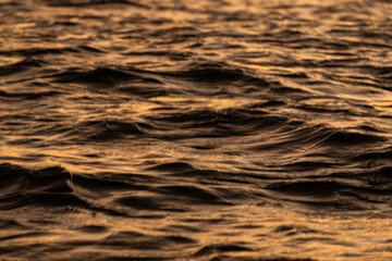 Golden sunrise in Itacaré, Bahia, Brazil. Boats floating on calm sea, yellow light on the horizon, tropical coastal landscape with warm tones and natural beauty.