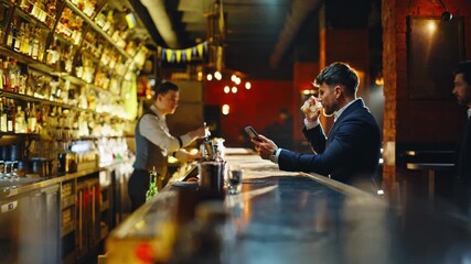 Lonely man resting bar counter with cocktail. Formal suit guy meeting friend