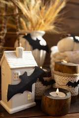 Decorative wooden candlesticks with candles Autumn decor in the style of Halloween holiday.