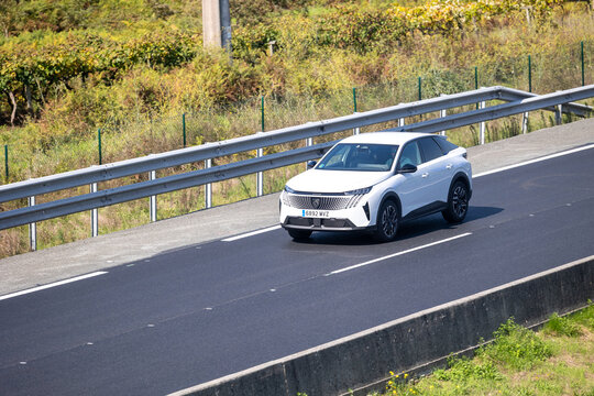 White peugeot 408 suv driving on highway road