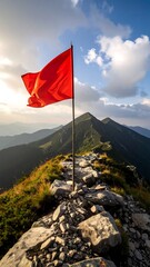 Red flag atop a mountain ridge at sunset