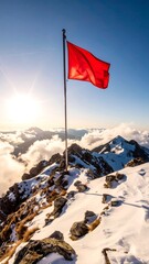 Red flag on a mountain summit at sunrise