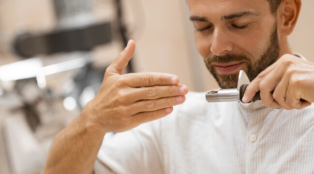 Young caucasian male roasting coffee beans with precision and aroma evaluation
