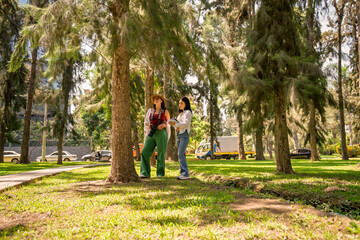 Fototapeta premium Women biology students doing urban forest fieldwork