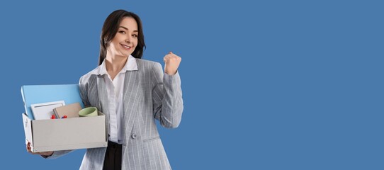 Happy dismissed businesswoman holding box with personal stuff on blue background with space for text