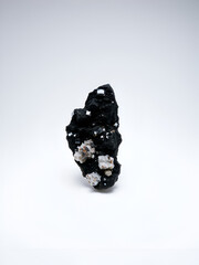 Shiny goethite mineral specimen on white background, crystal, science