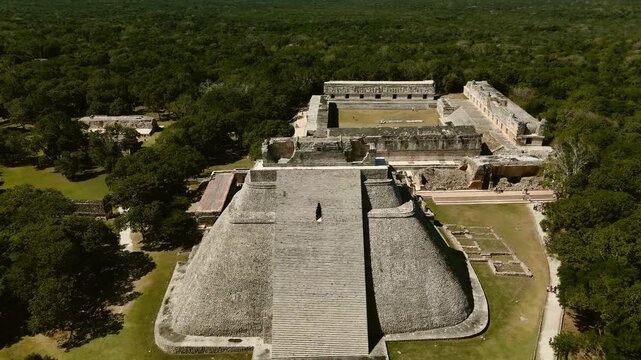 Aerial push in from Pyramid of the Magician to Nunnery Quadrangle in Mayan ruins of Uxmal