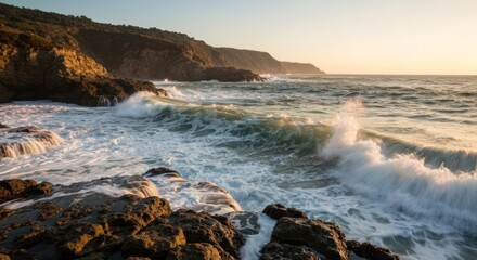 Dramatic coastal waves crashing on rocky shore at sunset