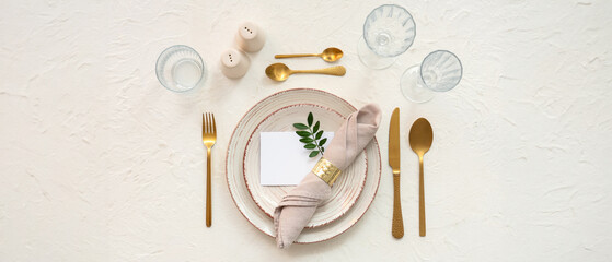 Set of clean tableware with blank card on white background. Top view