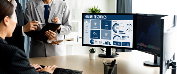 Human resources management software on computer screen helping human resources employee to manage...