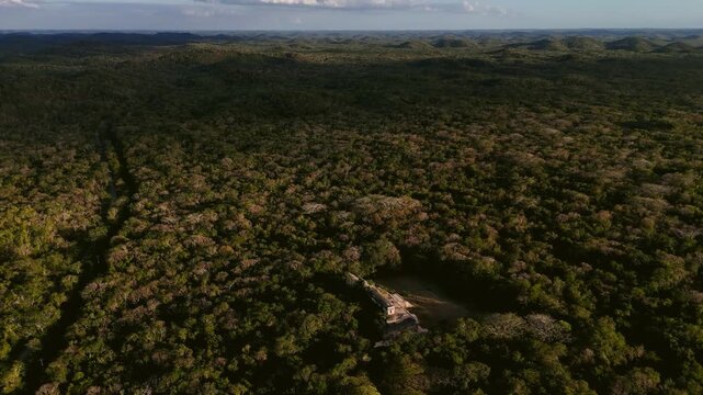 Aerial push in with tilt framing palace in Mayan ruins of Labna, Yucatan