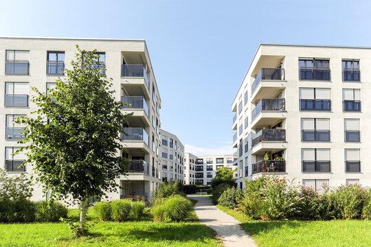 Residential area with ecological and sustainable green residential buildings, low-energy houses with modern apartments, new green urban landscape in the city - Powered by Adobe