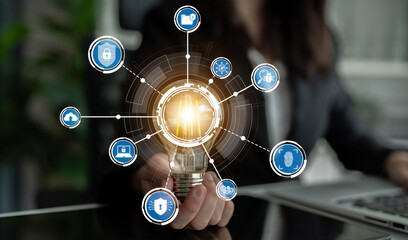 A professional hand holds a light bulb symbolizing innovation, with interconnected icons...