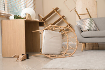 Overturned chair in living room after earthquake