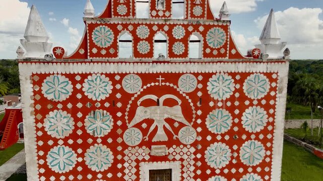Pull-back crane up shot revealing the double-headed eagle emblem on the facade of Templo de Santiago Apostol in Uayma, Yucatan, Mexico