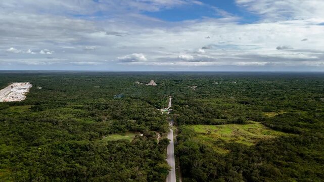 Distant Push-In Shot of Chichen Itza Pyramid in Yucatan, Mexico. Ancient Maya landmark surrounded by jungle