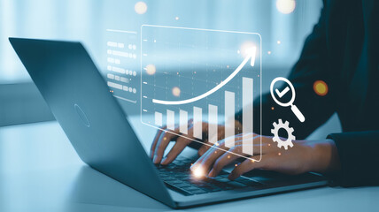 Business professional analyzing financial data and growth charts on a laptop screen with digital analytics overlay