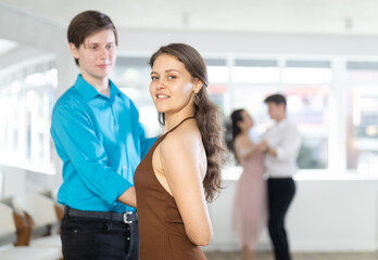 During rehearsal of reporting concert, guy and girl participants of dance workshop perform figure waltz. Several couples practice and hone their skills in performing waltz, classic slow dance style.